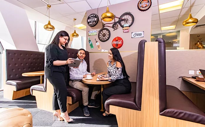 Coworking Space with people networking, collaborating, or working at dedicated desks with a luxury fit out.